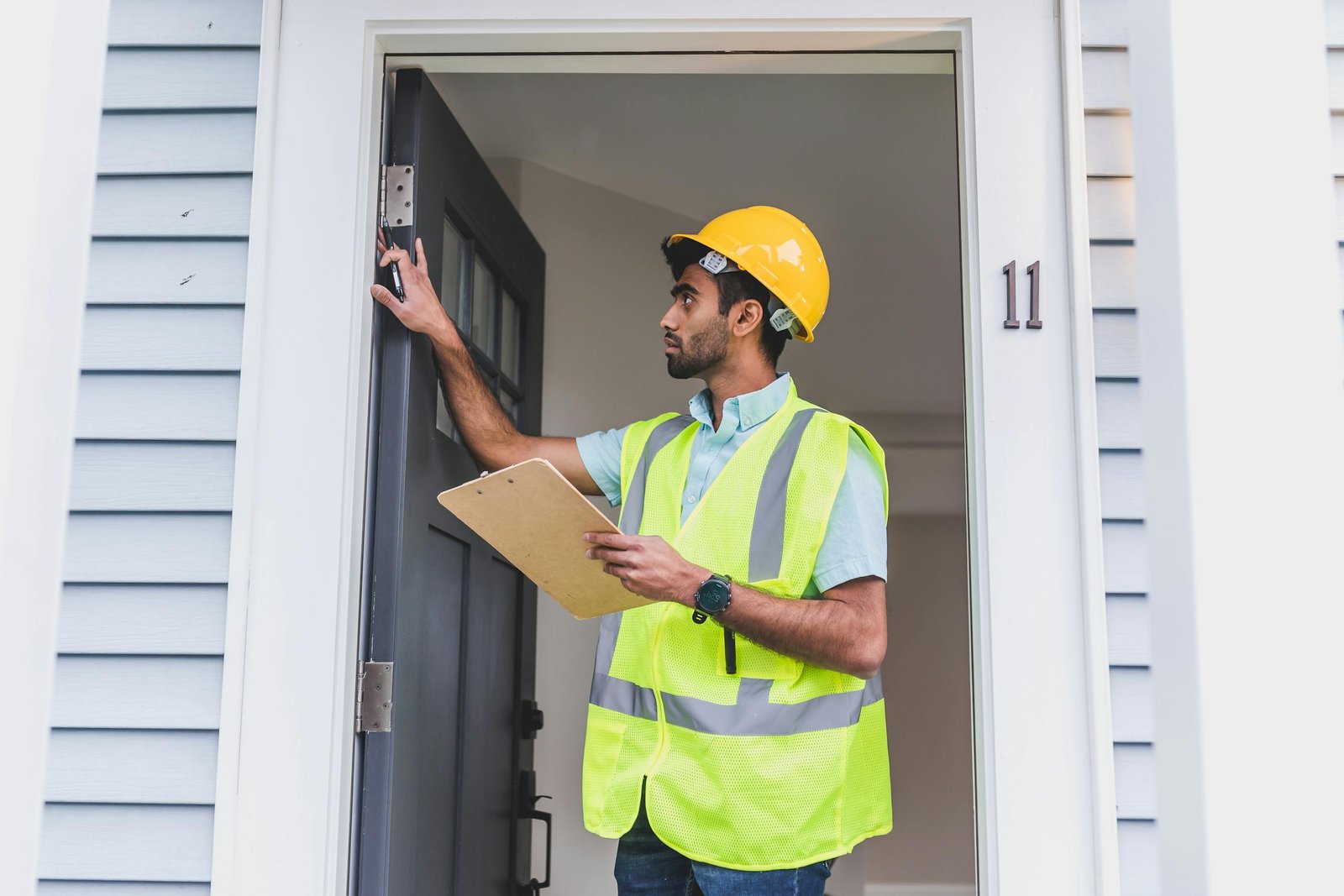 Professional inspector evaluating a home exterior for leak detection in Royal Palm Beach, FL