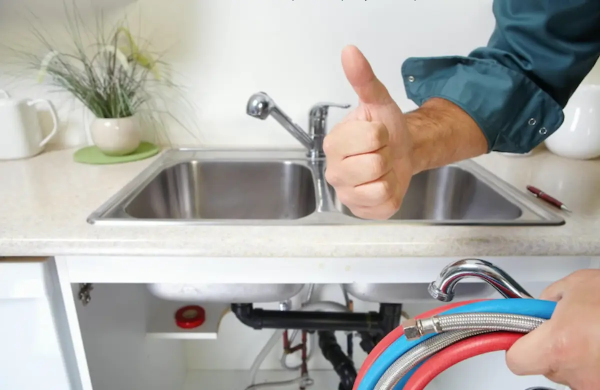 Plumbing technician completing a leak repair in a Lake Worth Beach home