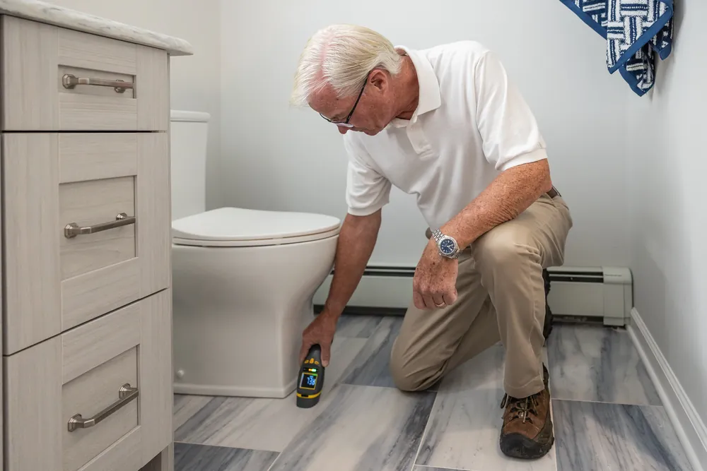 Technician performing foundation leak detection in West Palm Beach FL